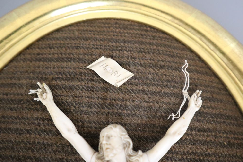 An ivory depiction of Christ, in gilt oval frame, carving 18cm